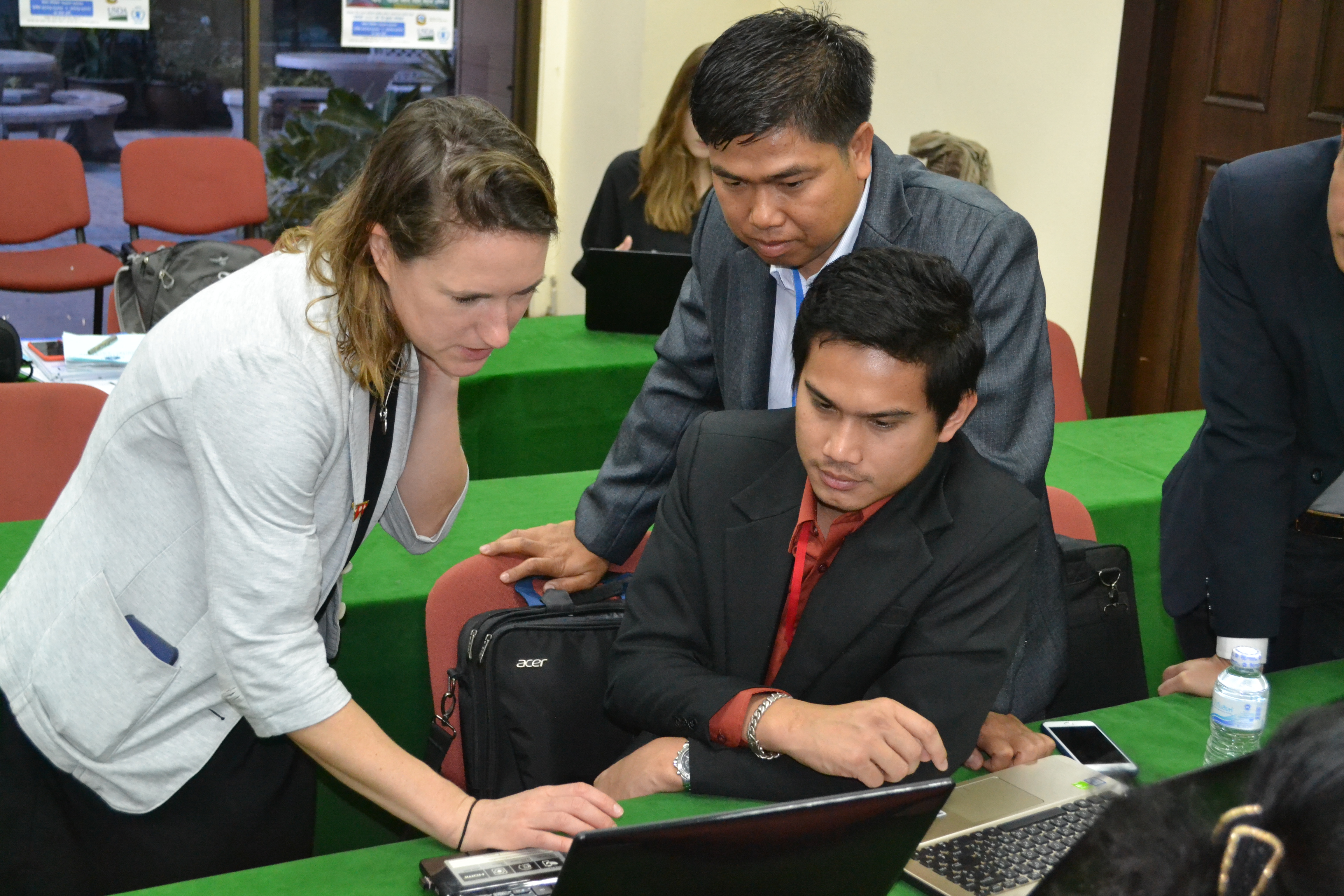 Noy Sidavong and Sitthideth Saengsouly discussing Laos's action plan with Imperial College's Dr Laura Appleby