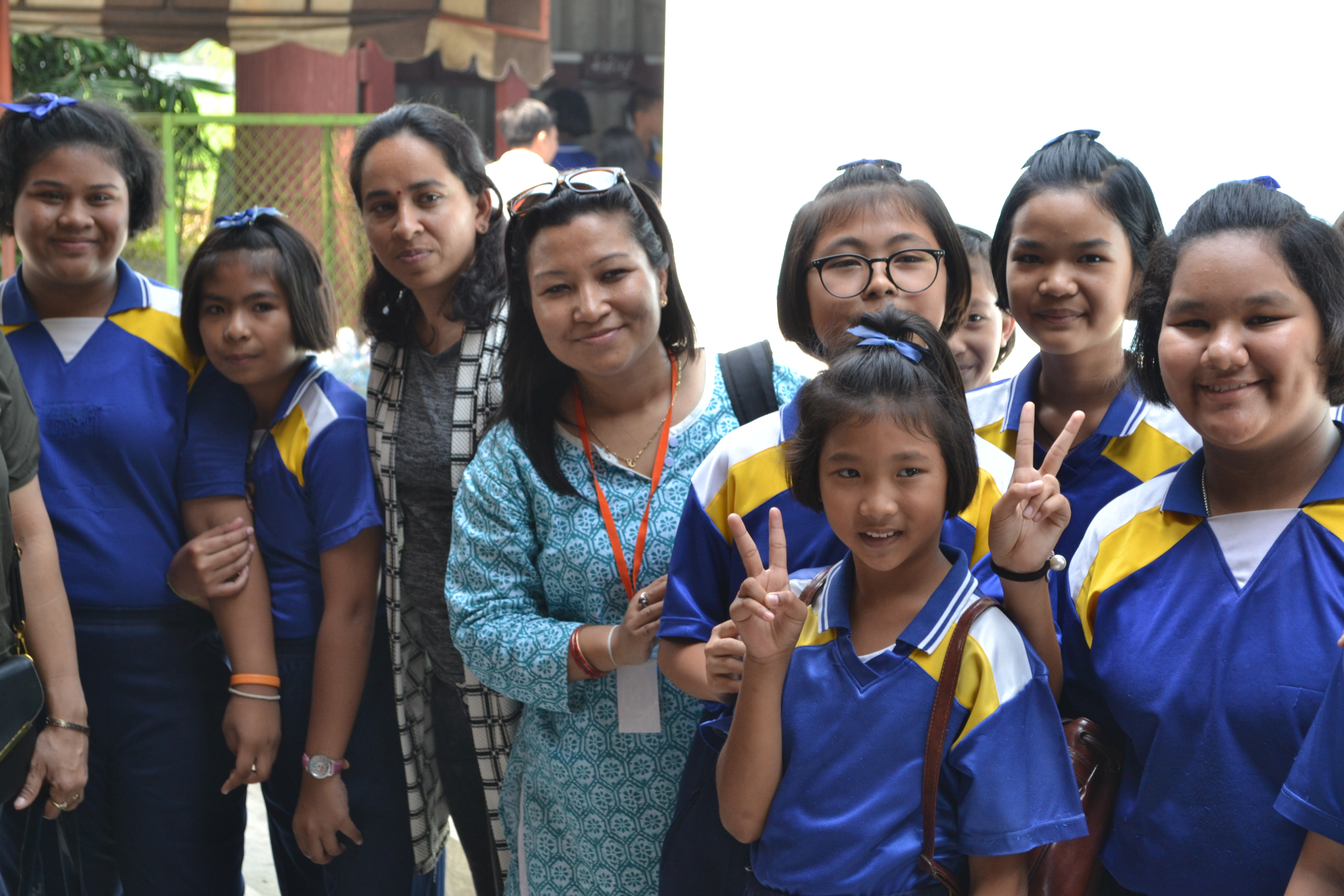 Nepal's Sajanmi Boyracharaya (c) with Thai pupils during school