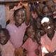 Kenyan schoolchildren looking through classroom window