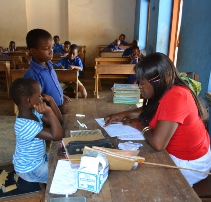 Teacher in Ghana with schoolchildren