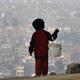 A child in Peru looks over Lima