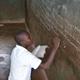 Boy writes on blackboard in Zanzibar 