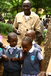 Kenyan school children taking deworming pills on a school-based deworming day