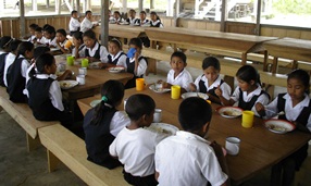 school children eating in a school canteen in Guyana